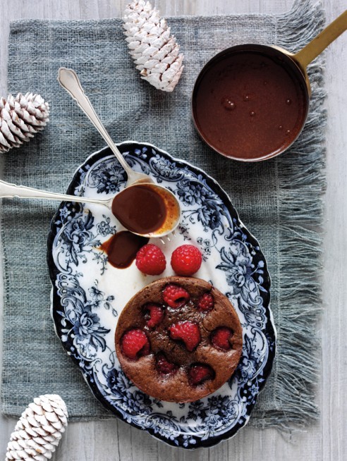 Baked raspberry and chocolate puddings with rich dark chocolate sauce